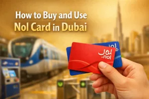A person holding a Dubai Nol Card with a subway station in the background, showing how to use it for travel.